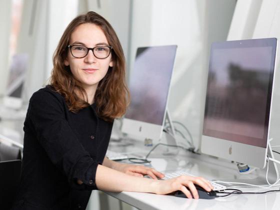 A student at a shiny computer.
