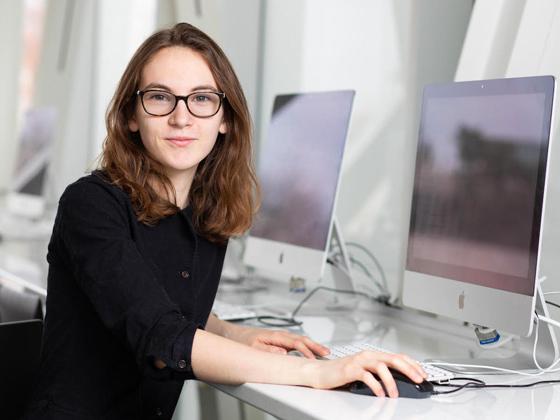 A student at a shiny computer.