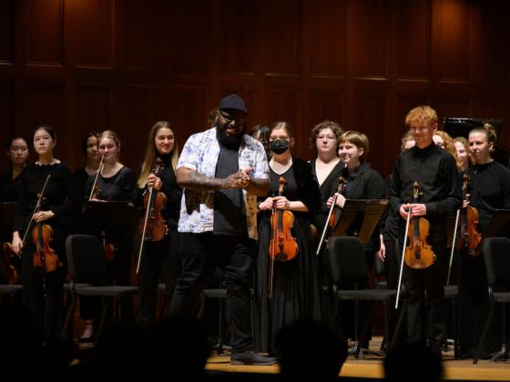 composer Michael Frazier acknowledges applause from the stage