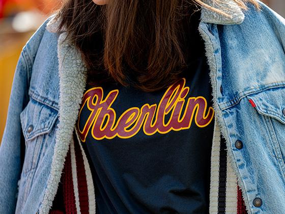 A person wearing an Oberlin shirt (close-up on the wordmark)