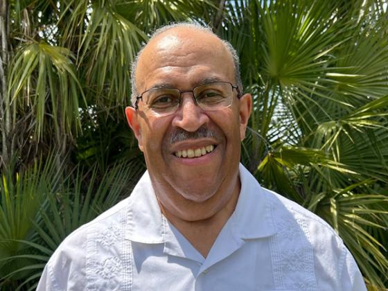 Wendell Russell, with palm trees in the background.