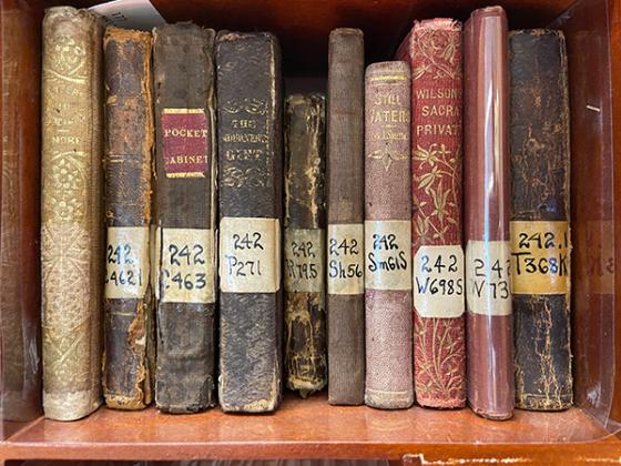 Antique books on a bookshelf.