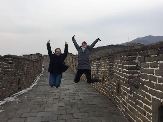 Two students jumping up at China's Great Wall.