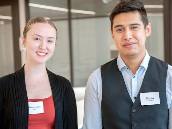 Two students smiling.