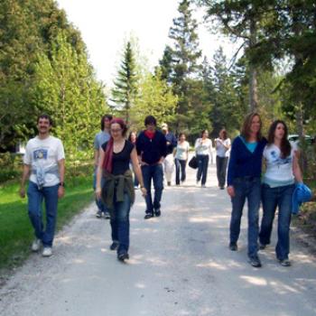 Group of about 10 people strolling along a path