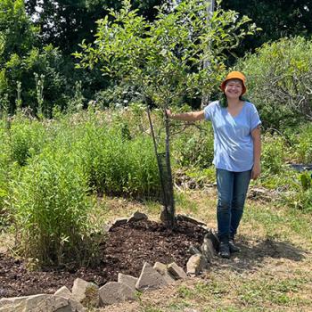 Amanda proudly shows a sapling she has planted.