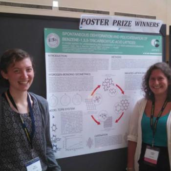Two students in front of a scientific poster under the heading Poster Prize Winners