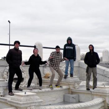 Five people on a marble structure
