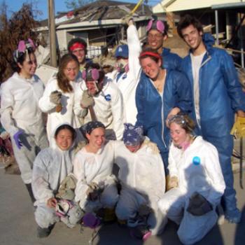 Group of volunteers in jumpsuits and protective gear