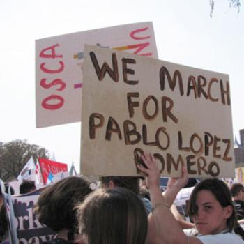 Protesters holding a sign reading We March for Pablo Lopez Romero