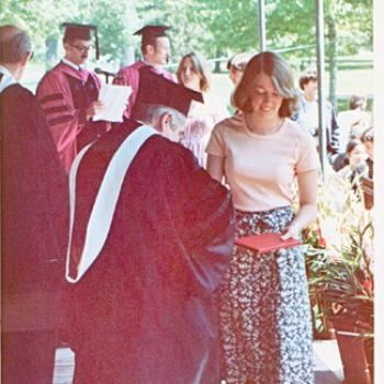 A 1970s-era student receives her diploma at Commencement