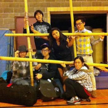 A group of students posing in a gym (wearing street clothes)