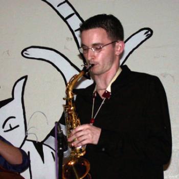 Jonah plays alto sax at the Cat in the Cream coffeehouse
