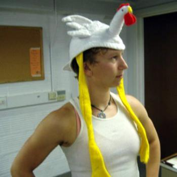 Kim wears a chicken hat with mock seriousness
