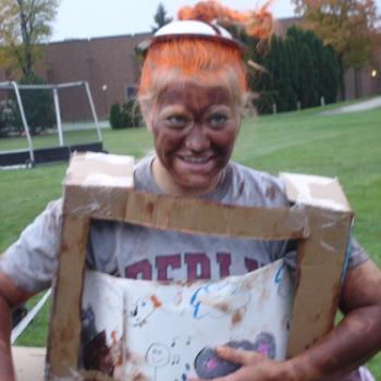 Meghan wears a honemade, cardboard TV costume at the soccer field.