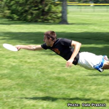 Mike appears to fly while diving for a Frisbee.