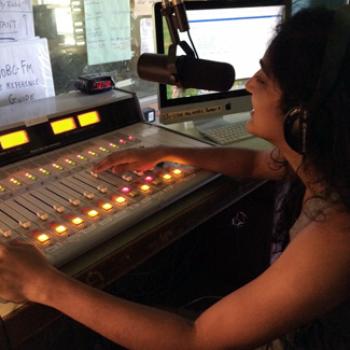 Nandita adjusts sound levels on the mixing board.