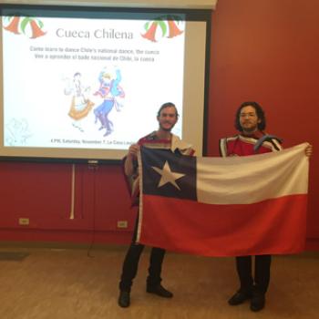 Two people hold up the flag of Chile