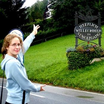 Nora points out a sign in German: Herzlich Willkommen in St. Wolfgang.