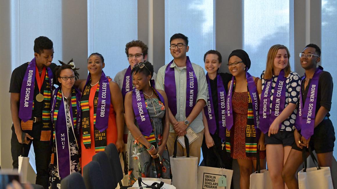 A group of ten students, each wearing a stole that reads Oberlin College Bonner Scholar.