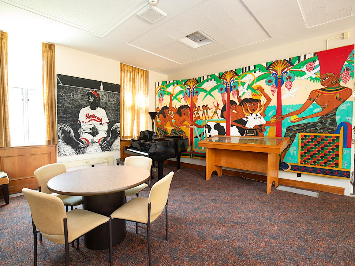 lounge area in residence hall with large photos and mural.
