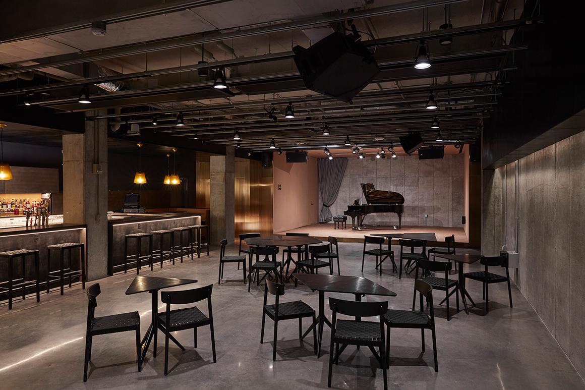 Interior of Birenbaum Innovation and Performance Space with cocktail tables and a stage
