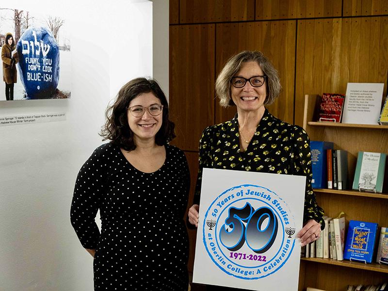 Shari Rabin and Cynthia Chapman hold "50th Anniversary of Jewish Studies" sign