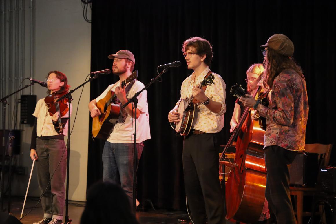 A folk band performing on stage.