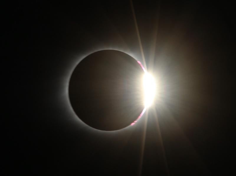 'Diamond ring' effect: sunlight from behind the moon creates the shape of a diamond ring around the moon