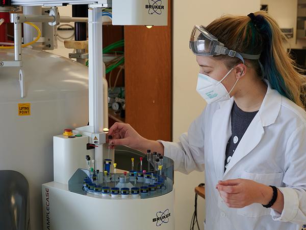 A student works with lab equipment.