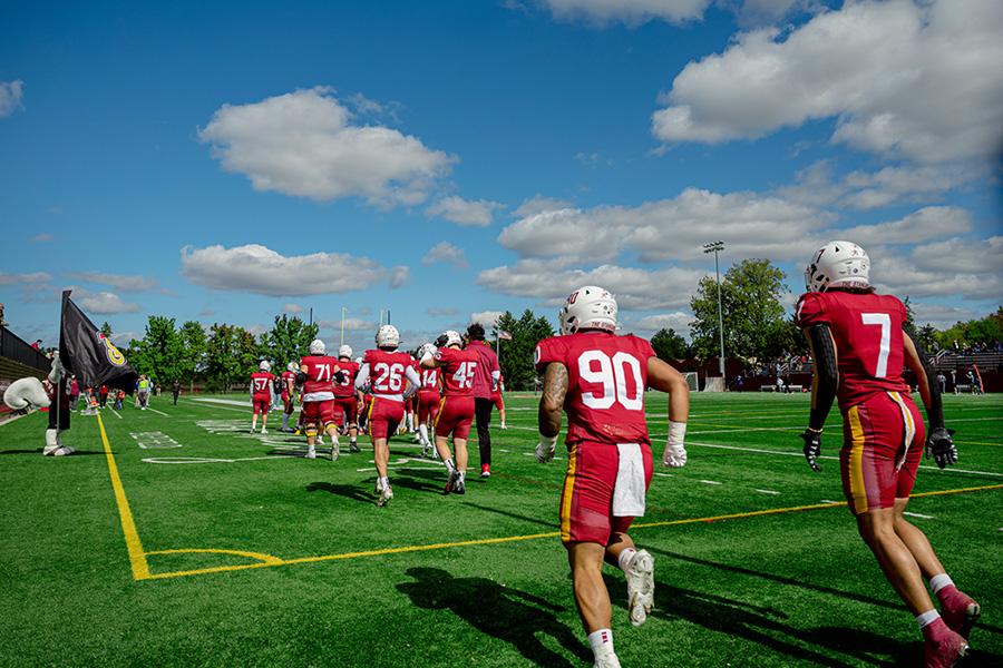 A football team runs onto the field.