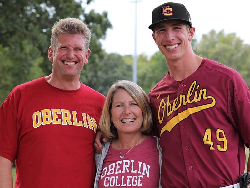 The Norrises with their son, who is wearing an Oberlin baseball uniform.