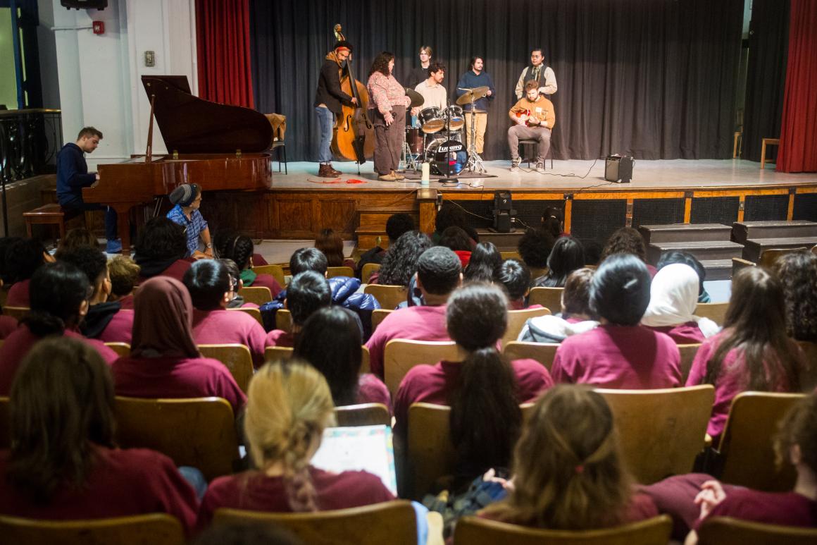 Oberlin Orchestra performing for an audience of younger students.
