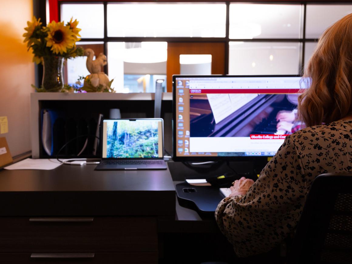 A staff member working on their computer in the admissions office.