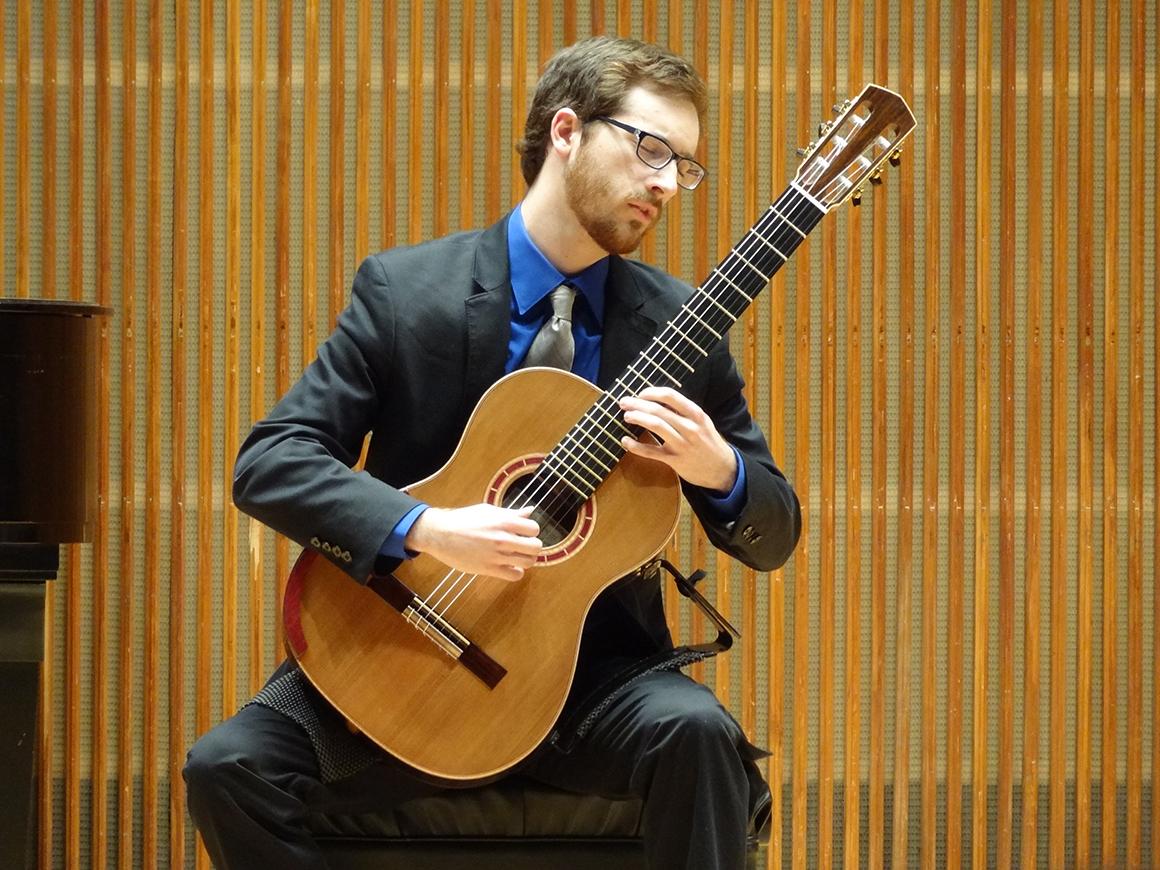 Student guitarist performing in Kulas Recital Hall.