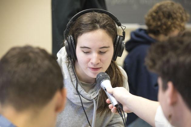 Students recording a podcast in class.