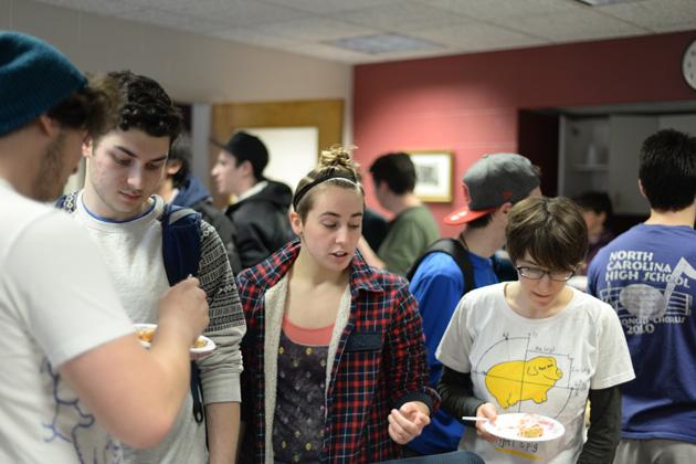 Students mingle and eat pie.