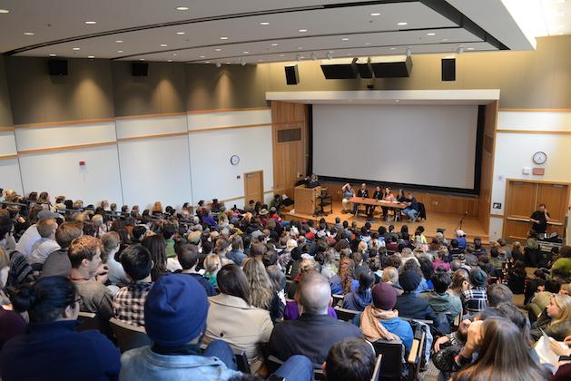 Dozens of students in a large lecture hall.