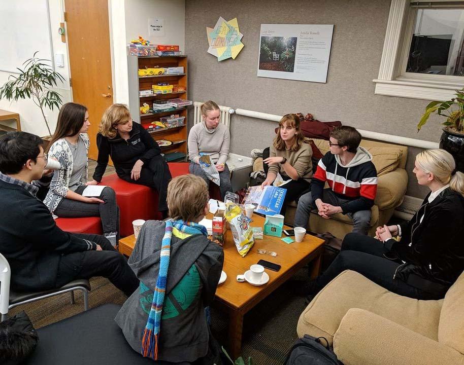 A group of 8 people meets in a lounge.