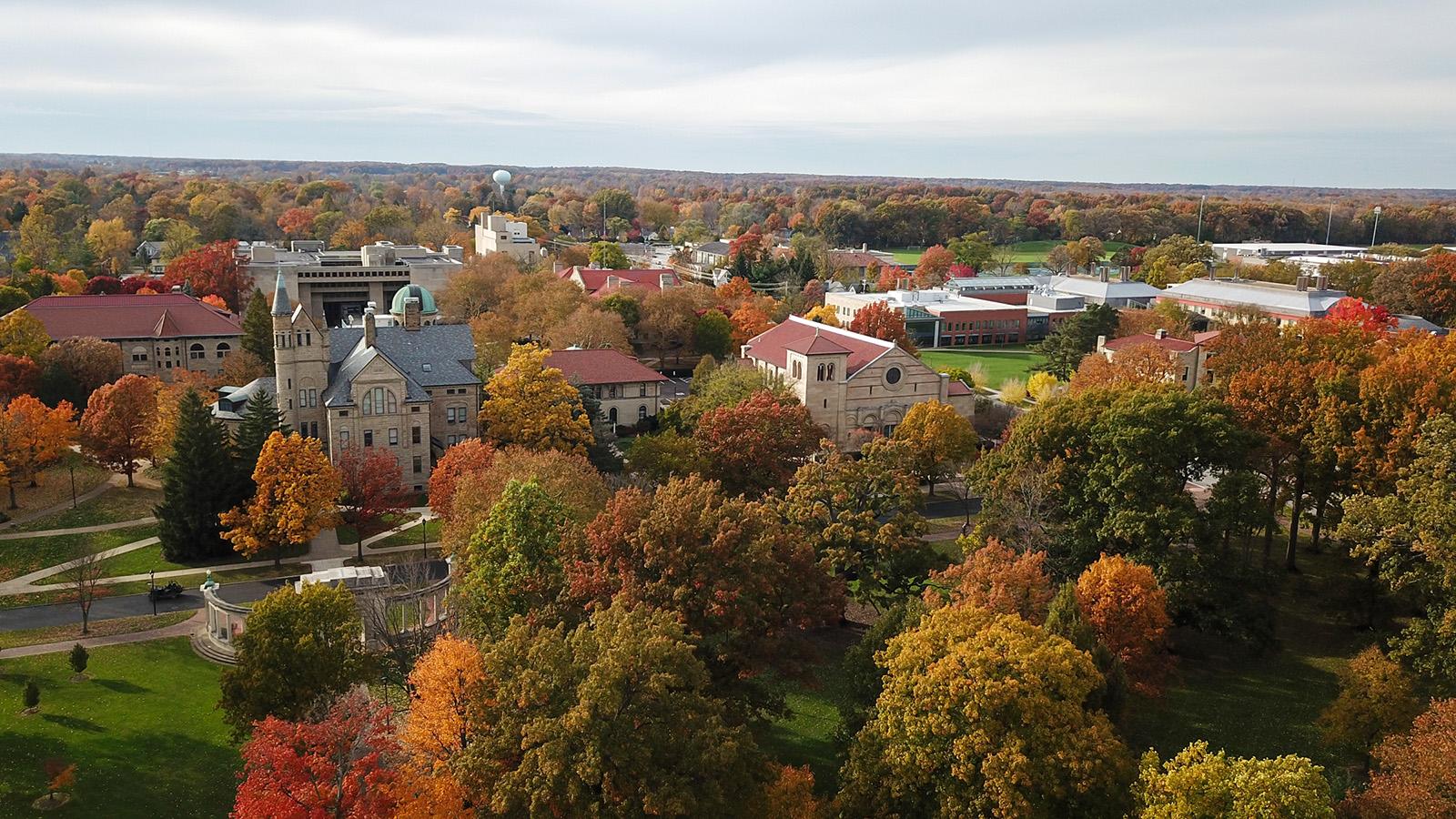 Aerial view of campus, with fall foliage.