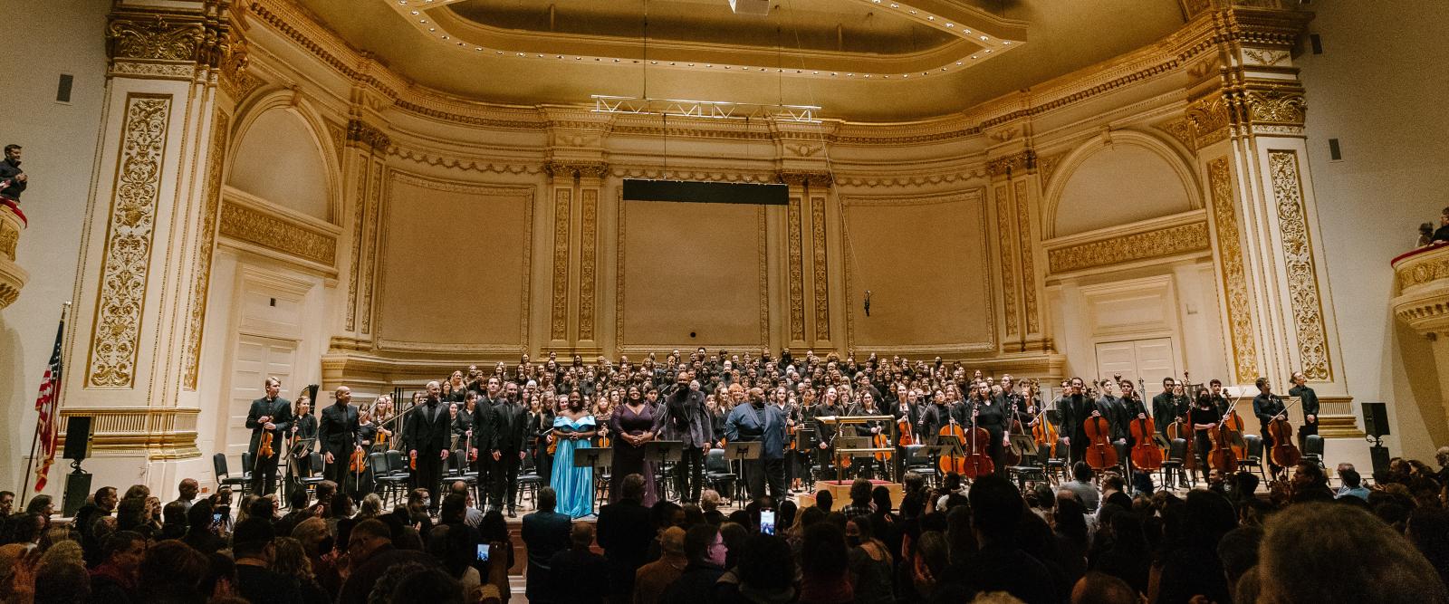 Oberlin Orchestra and choral ensembles on stage at Carnegie Hall.