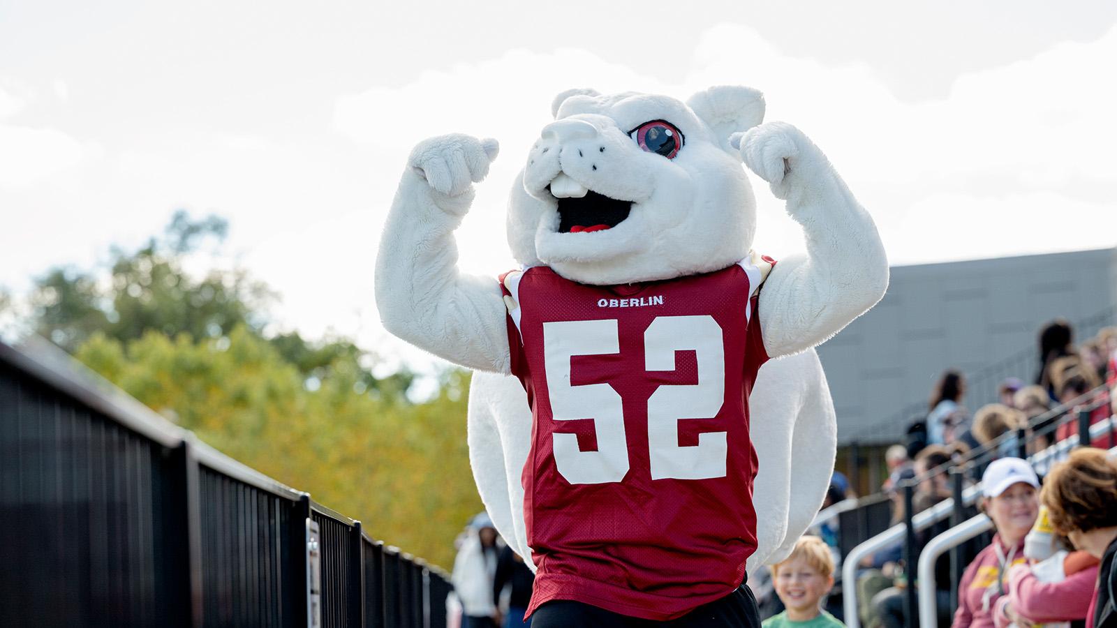 A white squirrel mascot wearing number 52 cheers at the sideline.