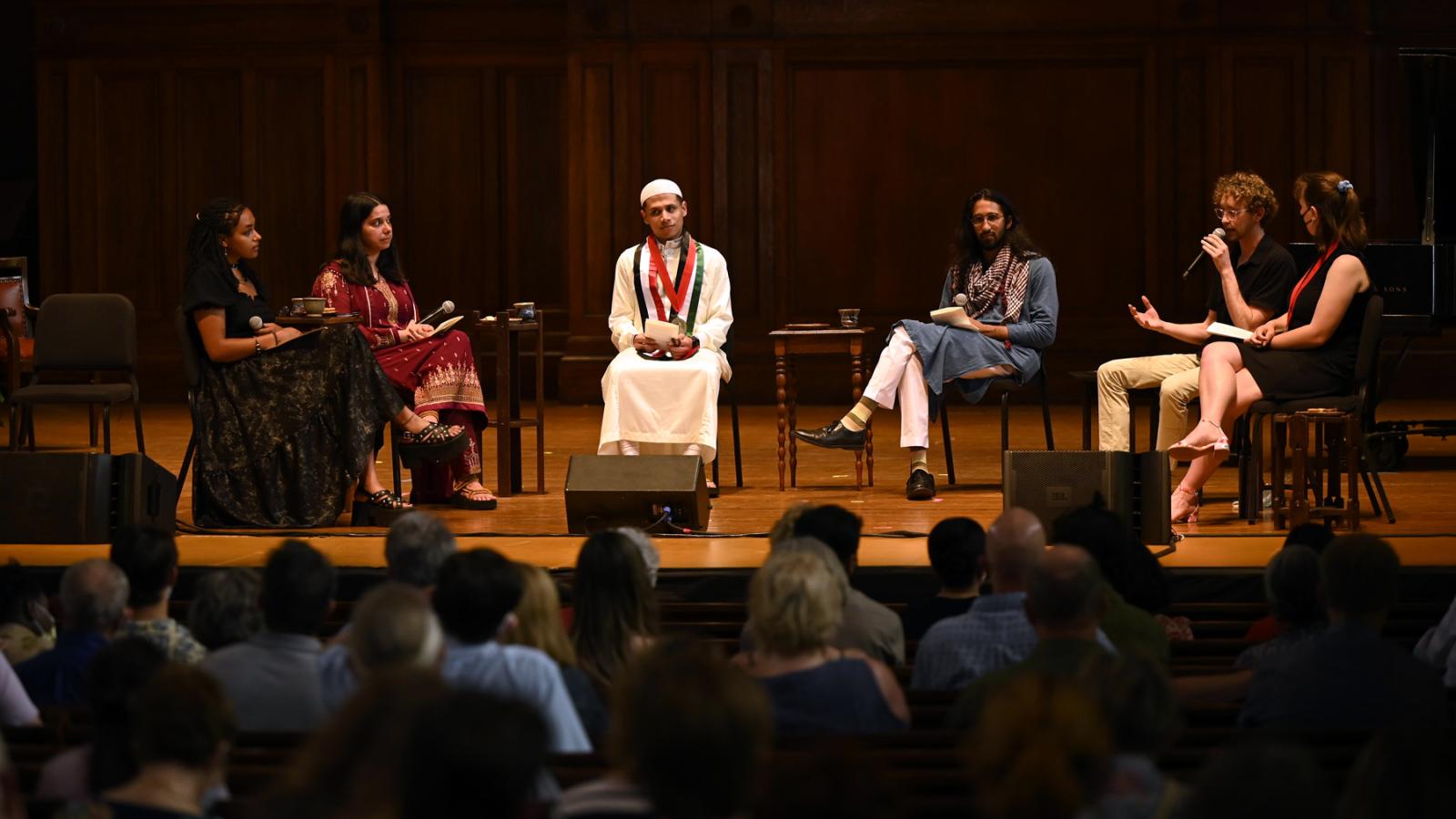 Panelists sit on stage at the 2022 Multifaith Baccalaureate