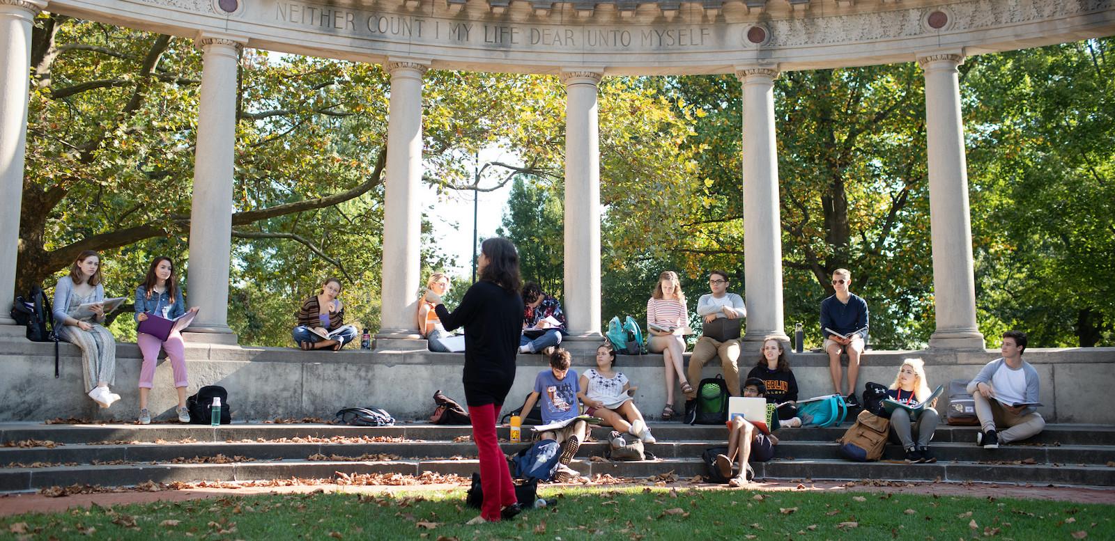 A class meets outside on campus.