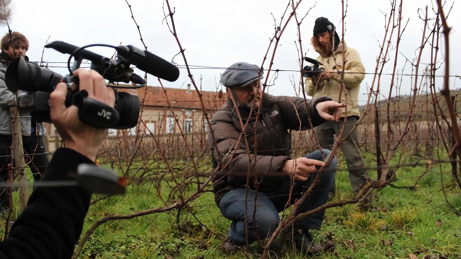 Students filming winemaker Vincent Laval in his vineyard.