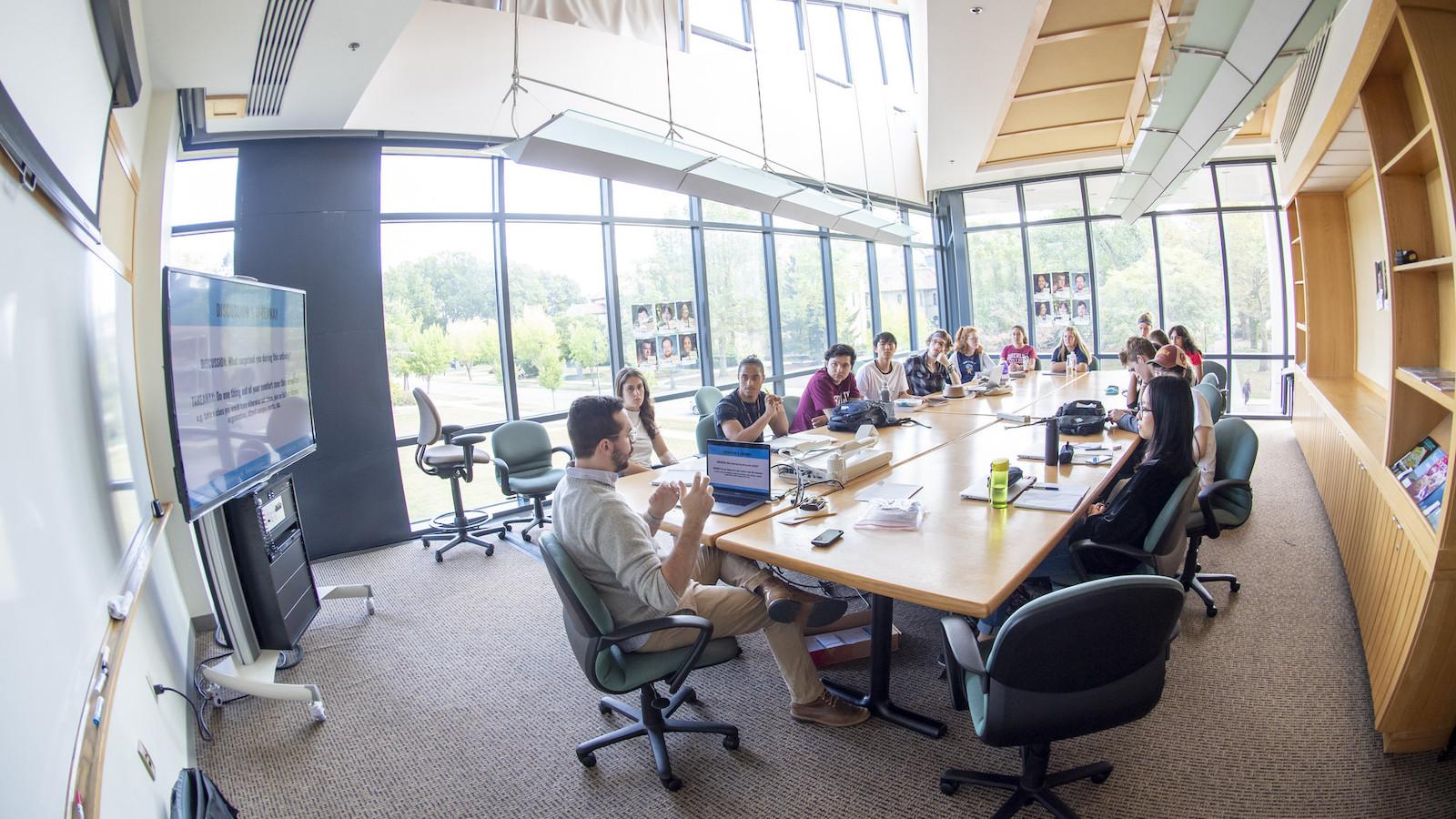 Discussion group around a large conference table.