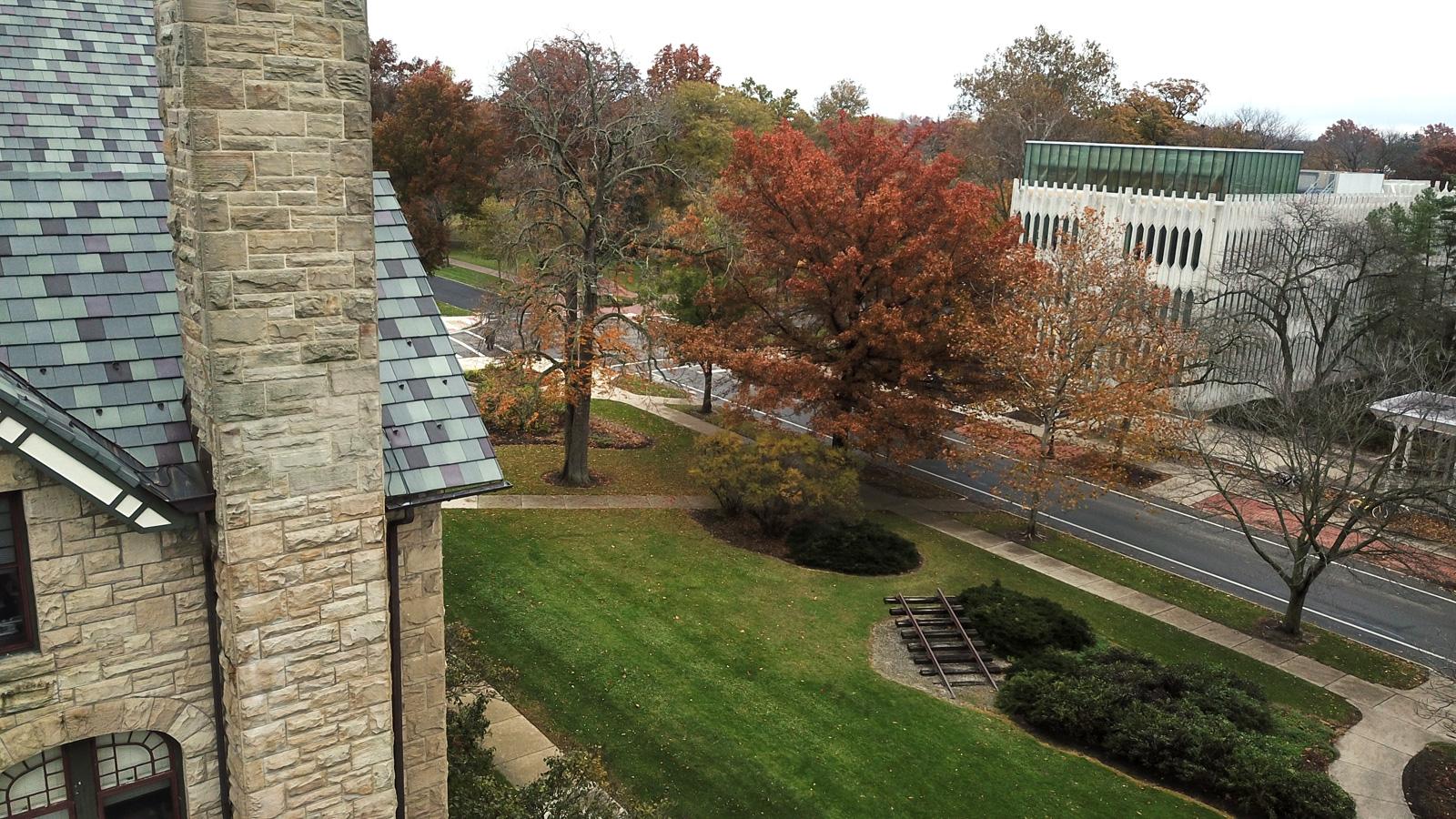 Aerial view of campus buildings and fall foliage.