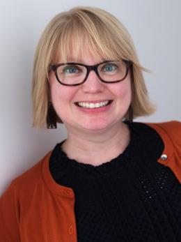 Christie Parris in dark shirt and red sweater.