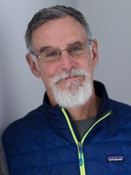T. S. McMillin wearing glasses and a blue nylon sport jacket.
