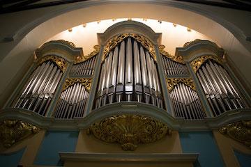 three large pipes on an organ.
